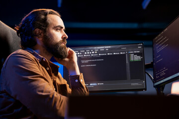 Computer scientist working from home developing software in JavaScript programming language. System...