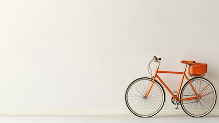 Fototapeta premium Bright orange bicycle parked against a minimalist white wall in a stylish indoor space
