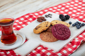 Cookie, Close-up of oatmeal cookies with raisins and chocolate on a plate in warm colors with a blurred background. Healthy Food Snack Concept.