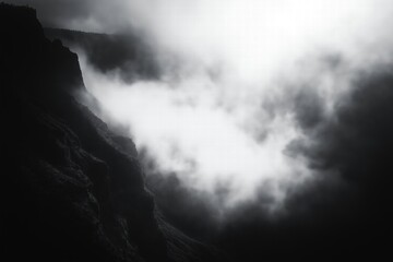 Dramatic clouds and fog envelop a rugged canyon during an overcast day in nature's raw beauty