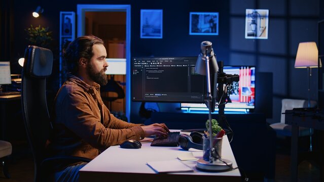 Programmer developing code on computer screen while in personal office using java programming languages. IT admin working with software tool, fixing database errors while working from home, camera B