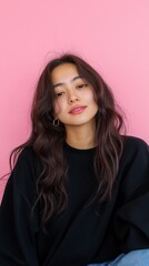 Fototapeta premium Young asian woman posing with pink background, wearing black and denim