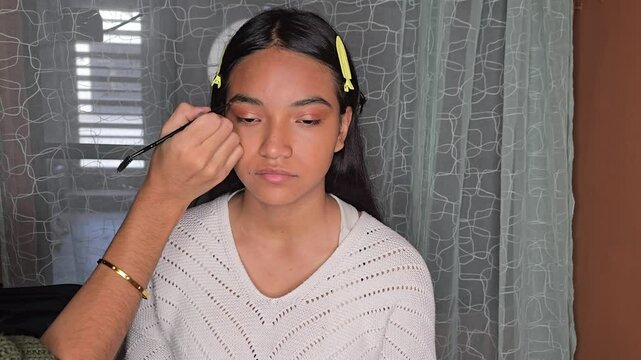 Using a dark pomade to define eyebrows 