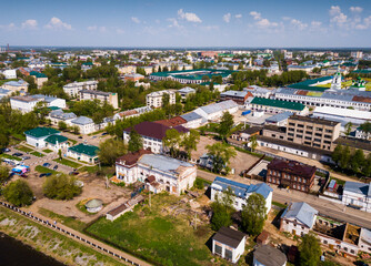 Scenic view from drone of Kostroma cityscape on bank of Volga River with complex of provincial trading arcades (Gostiny Dvor), Russia