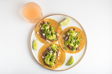 Barbacoa Meat Tacos with avocado salsa and Guava Juice Drink, view from above