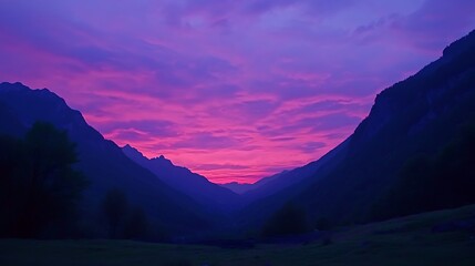 Obraz premium The perfect evening sky in the Alps, with a vibrant sunset blending with the cool blue of the mountain range, creating a stunning contrast of colors over the peaceful valley below 