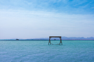 Tranquil seascape with hammock and clear blue skies for relaxation and escape