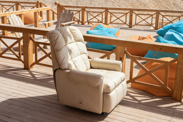 Cozy outdoor seating with recliner and bean bags on wooden deck