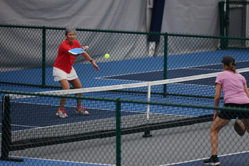 Senior woman playing pickleball