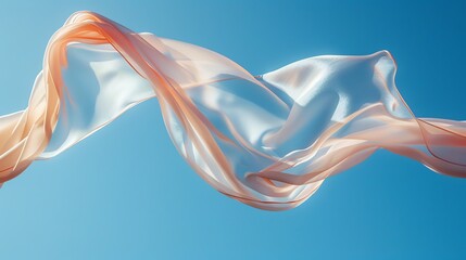 Fototapeta premium Flowing peach silk fabric against a blue sky.
