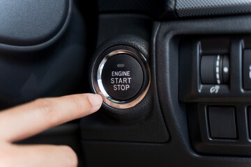 Close up of someone trying to ignition car by push start button.