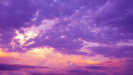 Beautiful colorful sunset background. Blue purple pink orange yellow gold. Evening sky with clouds.