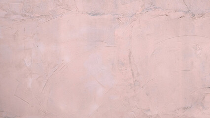 Pinkish salmon rough cement or plaster wall texture or background. Modern peach wall with shovel textured effect.
