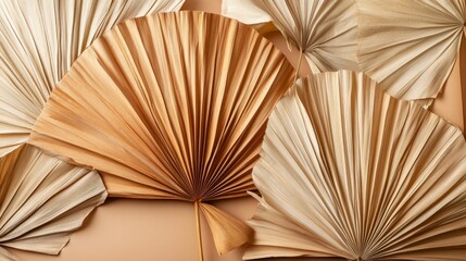 75.Elegant arrangement of dried palm leaves fanned out to show off their varied shades, from warm beige to deep brown. The natural textures and patterns of the leaves are visible, with each leafâ€™s