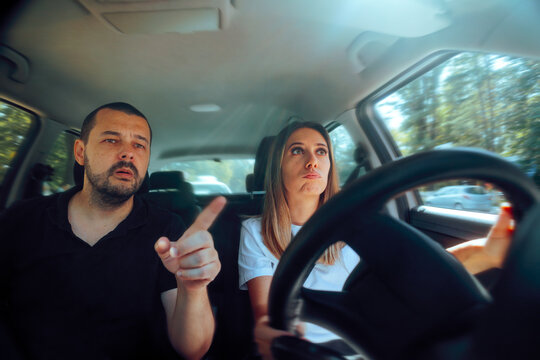 Driving Instructor Explaining a Female Student Where to Go. Men explaining his wife the direction they need to go from passenger seat
