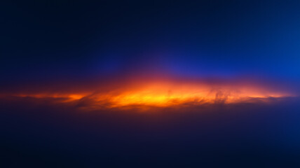 Fototapeta premium オレンジ色に光るスモークの不思議な背景