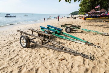 Boat Trailers on a Tropical Sandy Beach