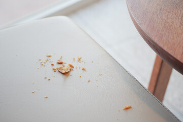 Crumbs on a light chair in a modern cafe suggest a vibrant atmosphere