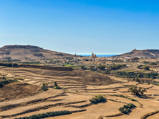 Hills with church visible in distance - panoramic view from the Old medieval citadel, Gozo island