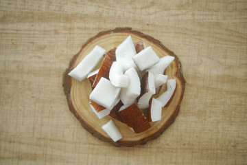 slice of fresh coconut on a table cloth 