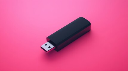 Black USB flash drive on pink background. Ideal for technology, data storage, and digital concepts.