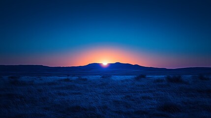 Sunset Over Silhouetted Mountains and Grassland