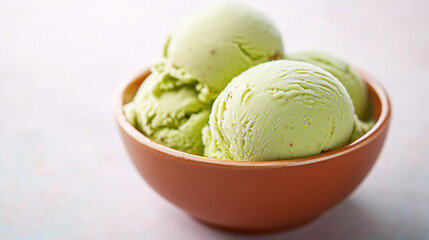 Pistachio ice cream scoops in a bowl  
