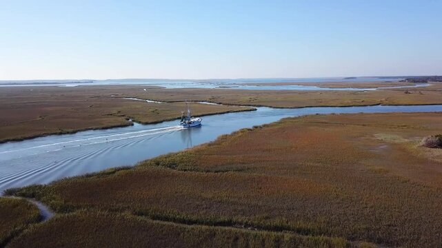 Aerial view of commercial fishing boat coming into port on the Atlantic coast.