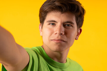 Young person expressing various emotions and body pains, pointing, using a cellphone, with colored backgrounds and wearing shirts of different colors