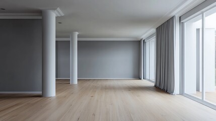 A spacious, minimalist room with large windows and light wooden flooring.