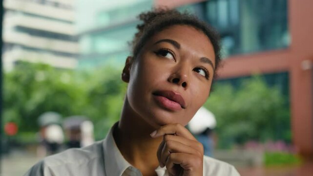Thoughtful African American thinking contemplate pondering decision choosing work entrepreneur woman female girl businesswoman business solve puzzled solution manager consider planning city outdoors