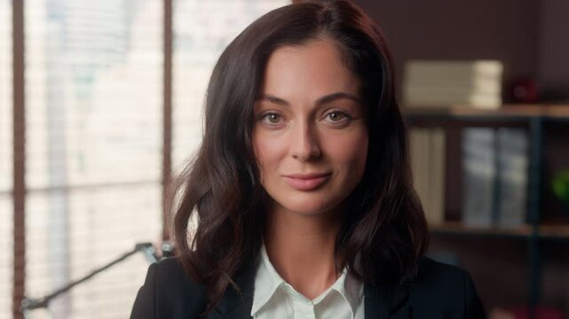 Confident Caucasian woman looking at camera smiling portrait female girl lady work businesswoman business office inside job employer manager leader femininity face professional millennial expression