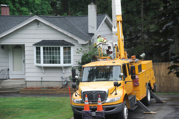 utility repairing truck outside house, repairing the electrical cable