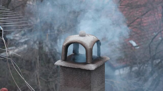 moke from the chimney of a cozy house, December in Serbi