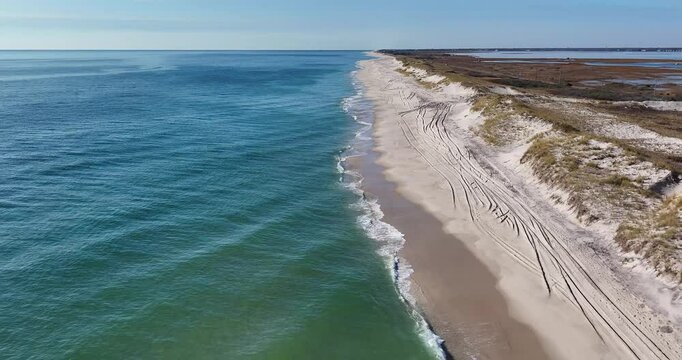 Southampton, NY, USA - 11-20-2024:  Late morning aerial, drone, video of Panquogue Beach on a sunny fall day.  30 FPS