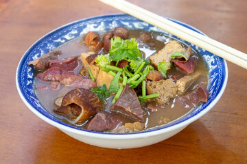 Bowl of Luzhu huoshao (pork stew with bread) on table