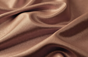 close-up of soft waves of silky fabric in trendy mocha mousse color