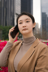 Confident Businesswoman Engaging in Communication Amid Urban Landscape