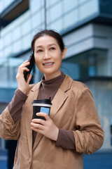 Confident Businesswoman Enjoying Coffee While Talking on the Phone