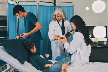A team of doctors and nurses are working to treat a female patient in the patient's room.