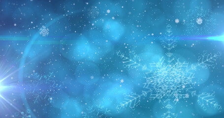 Image of snowflakes and lights on blue background