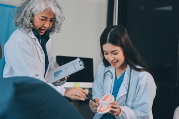 A team of doctors and nurses are working to treat a female patient in the patient's room.