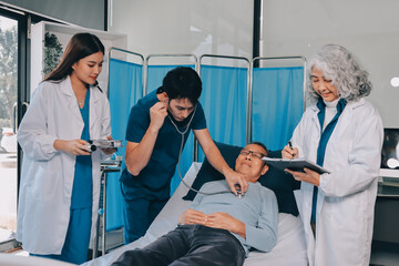 A team of doctors and nurses are working to treat a female patient in the patient's room.