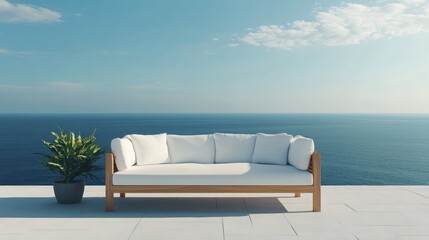 Modern outdoor sofa on a serene balcony overlooking the vast ocean under a clear blue sky with light clouds and a vibrant green plant in a pot