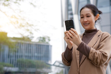 Joyful Woman Engaging with Smartphone in Modern Urban Environment