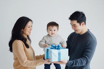 Dad and mom giving gift to son.