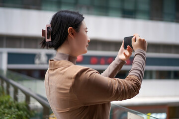 Capturing Moments: A Young Woman Taking Photos with Her Smartphone