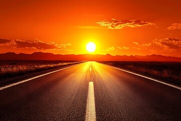 A long road leading into the distance, with mountains in the background and a sunset glow on top of them