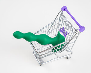 Green anal plug in miniature shopping cart. 