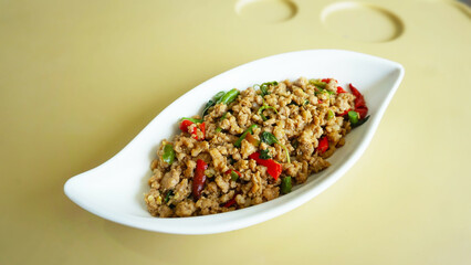 Stir-Fried Chicken with Basil: A mouthwatering dish featuring tender chicken stir-fried with aromatic basil, red peppers, and a savory sauce. Perfect for showcasing Thai cuisine, culinary delights.